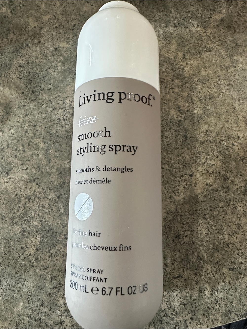 Living Proof Smooth Styling Spray in Beige and White